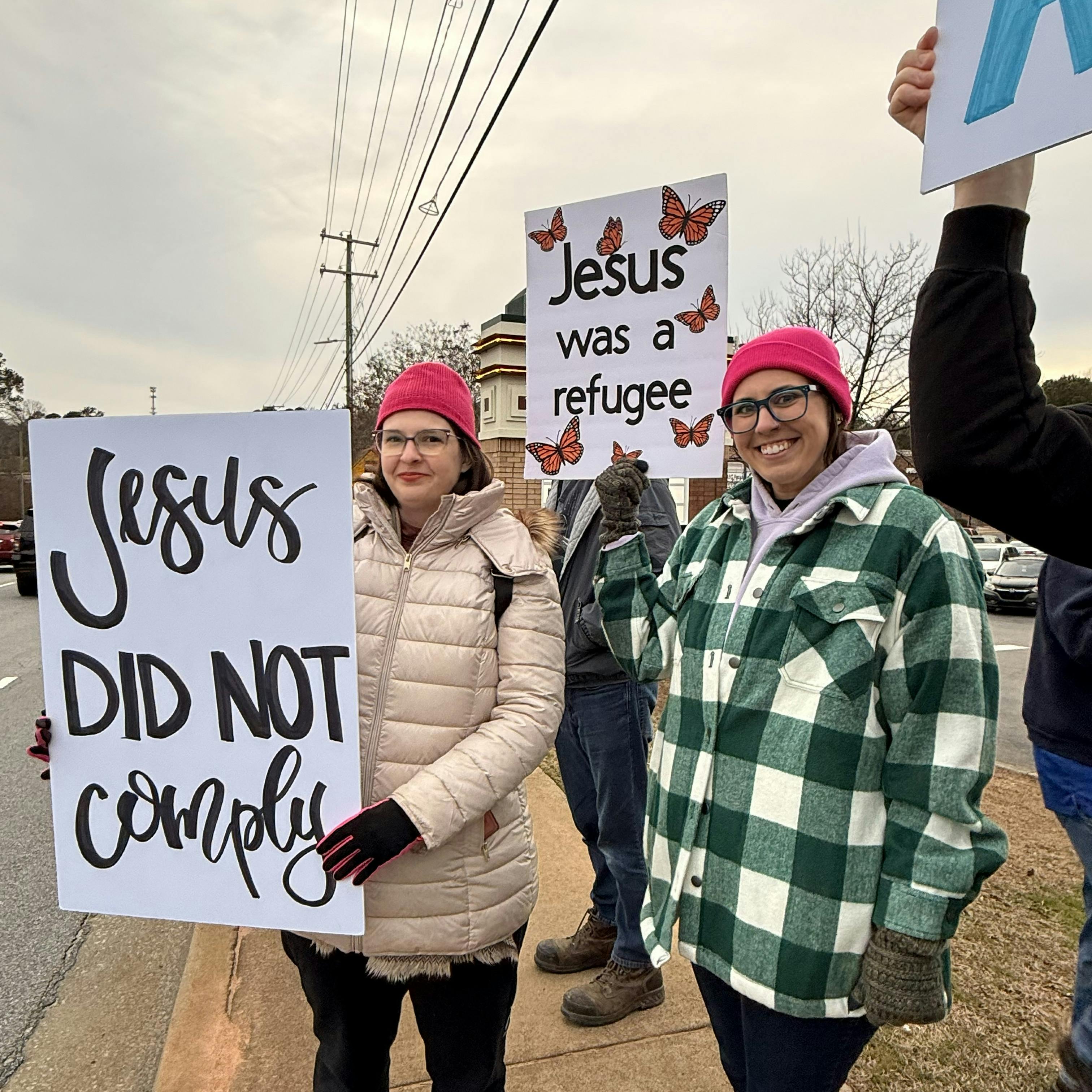 ICE Protestors holding signs