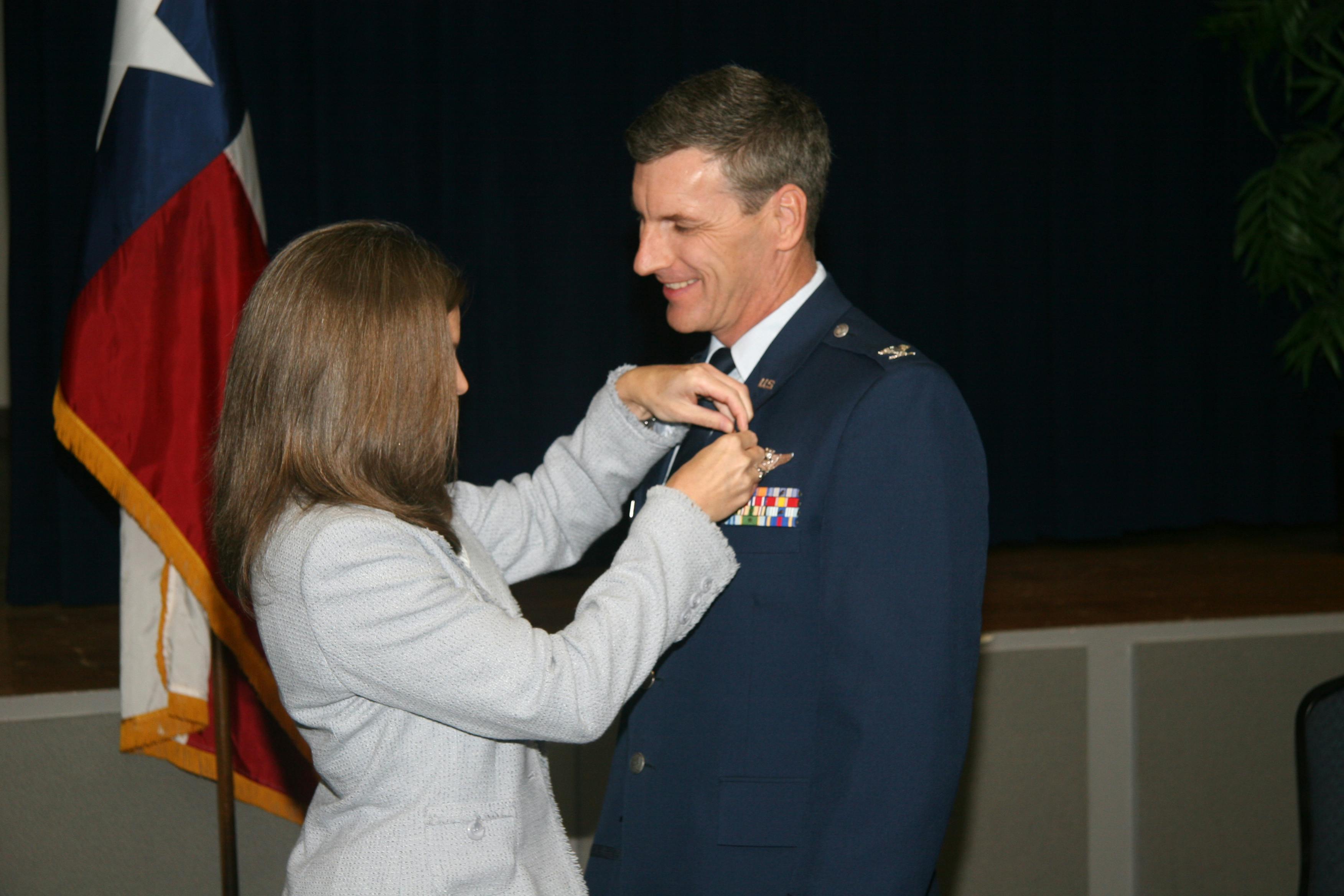 LeeAnn pinning medal on Dr Pete at USAF Retirement Ceremony