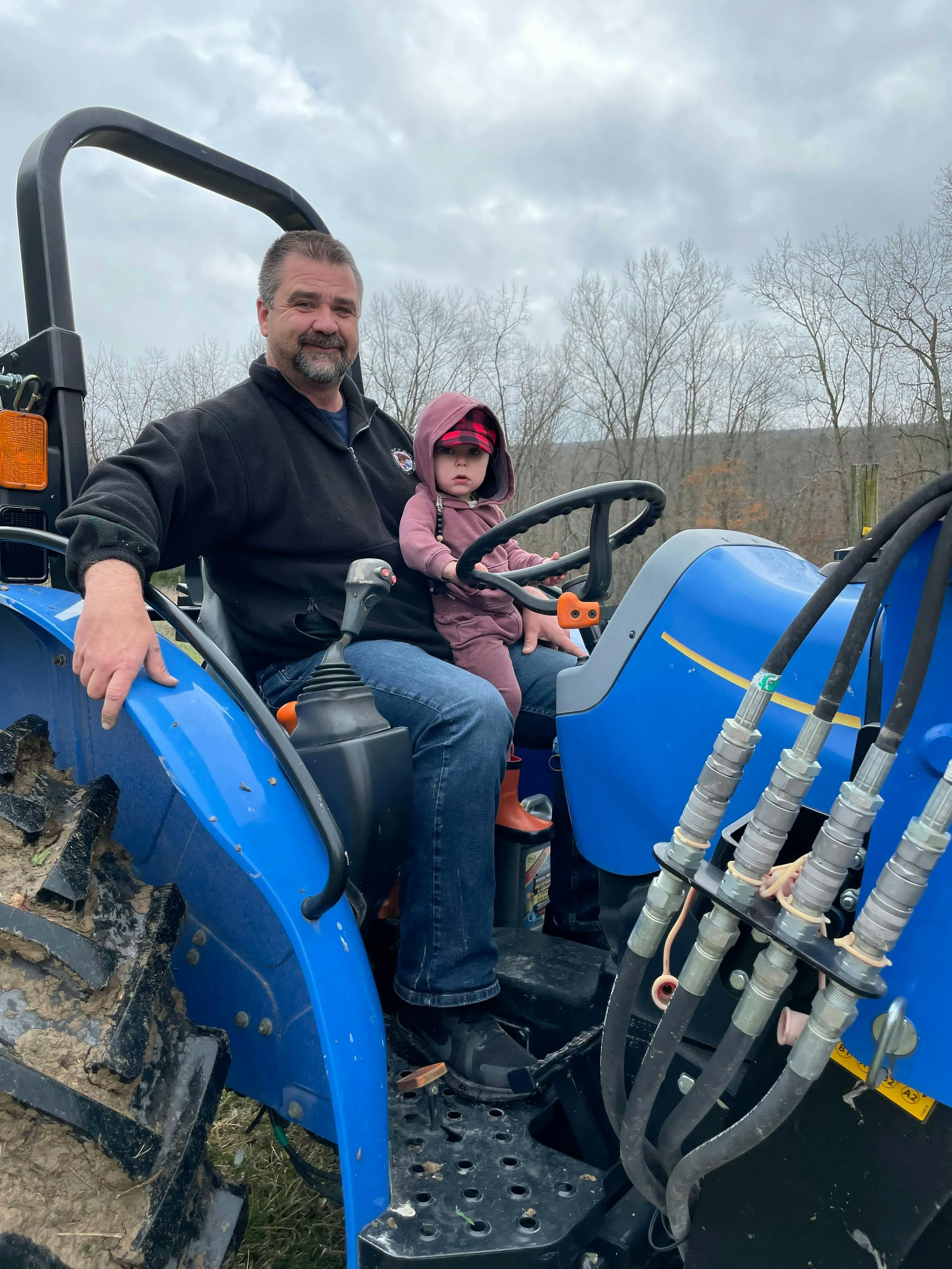 photo of kent and grandson on tractor