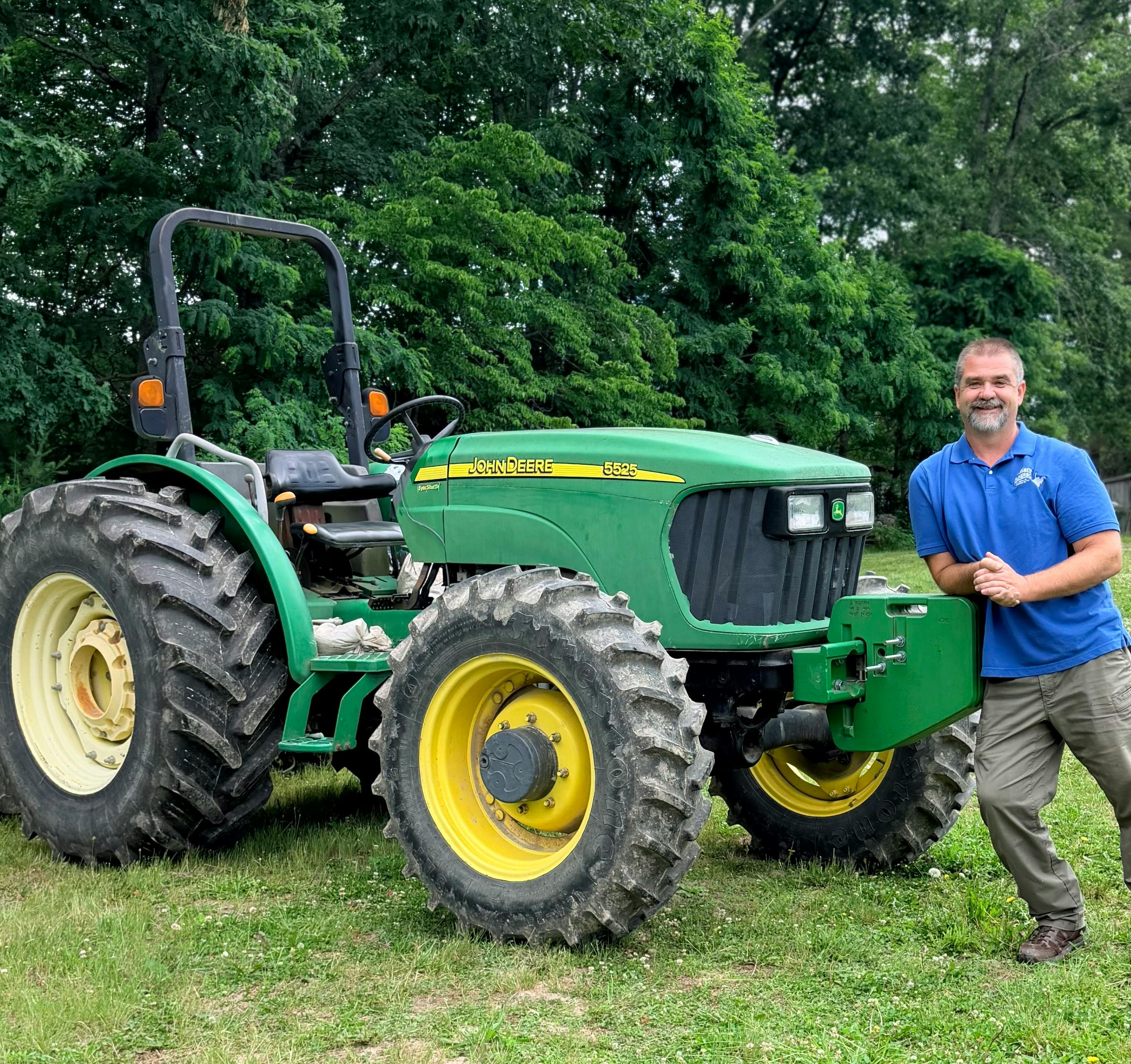 Kent leaning on tractor