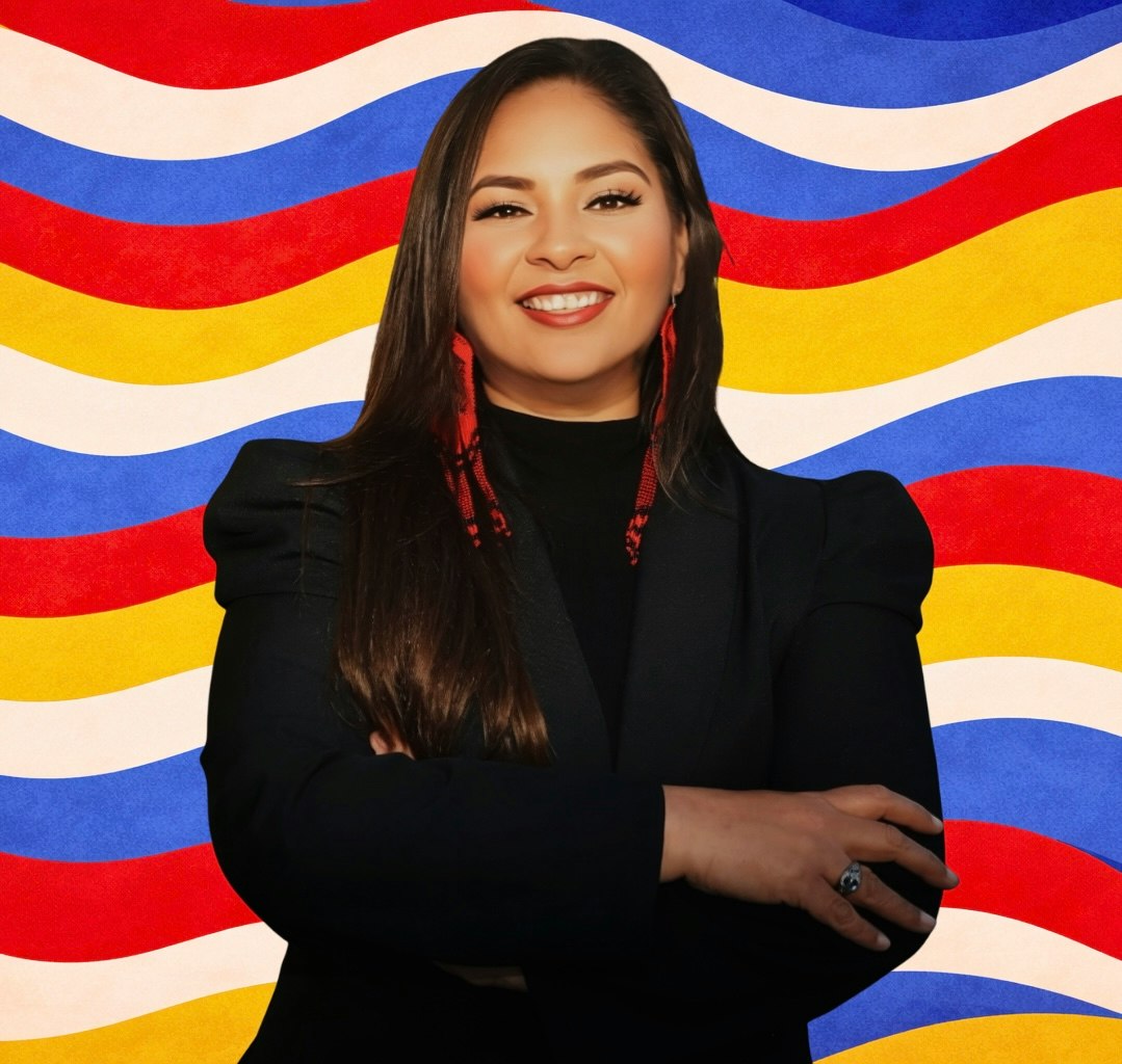 Maria Pacheco with arms folded on bright wavy background