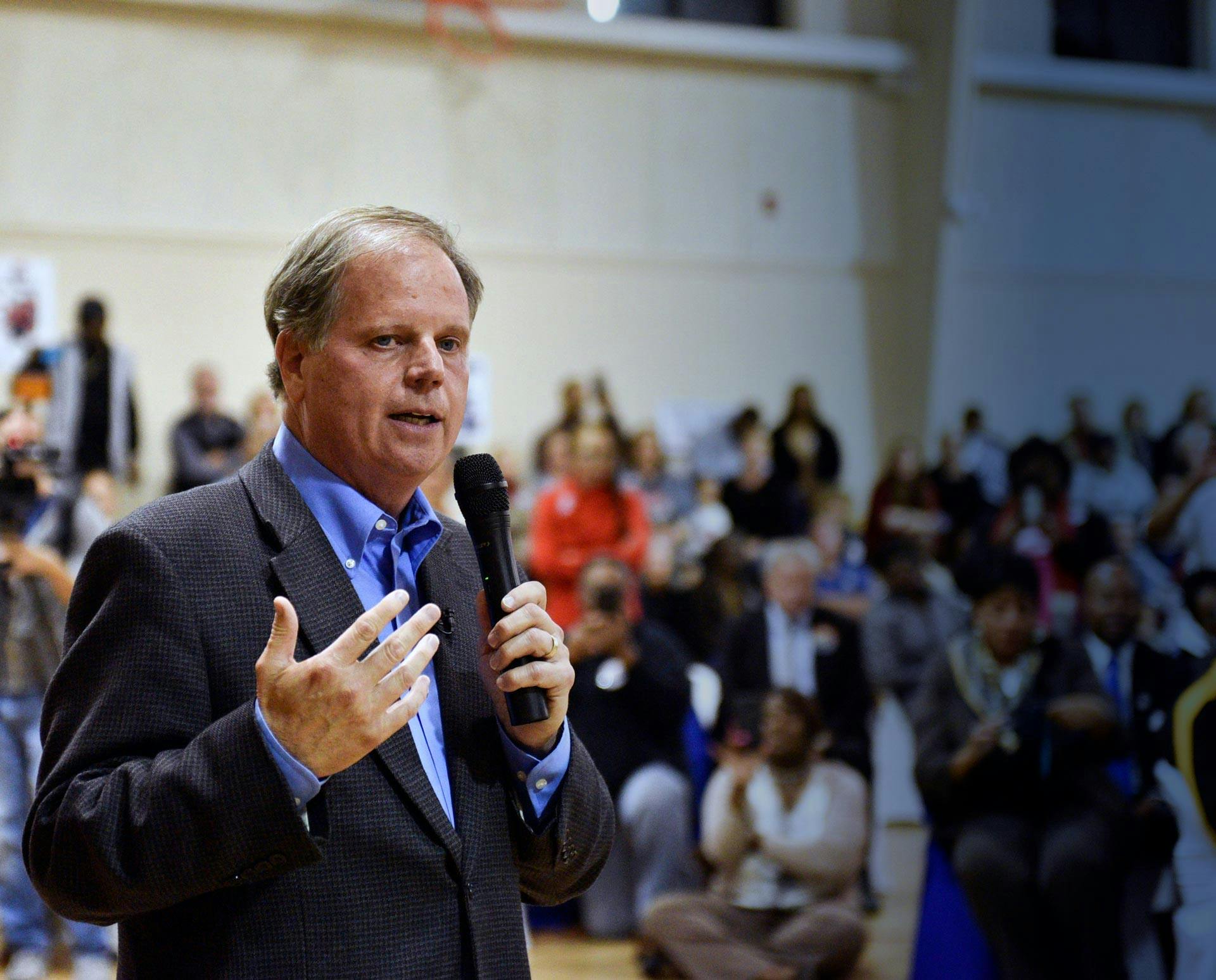 Doug Jones speaks before a rally crowd.