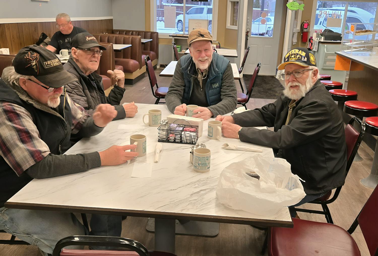 Fred Clark at a table with fellow Wisconsinites