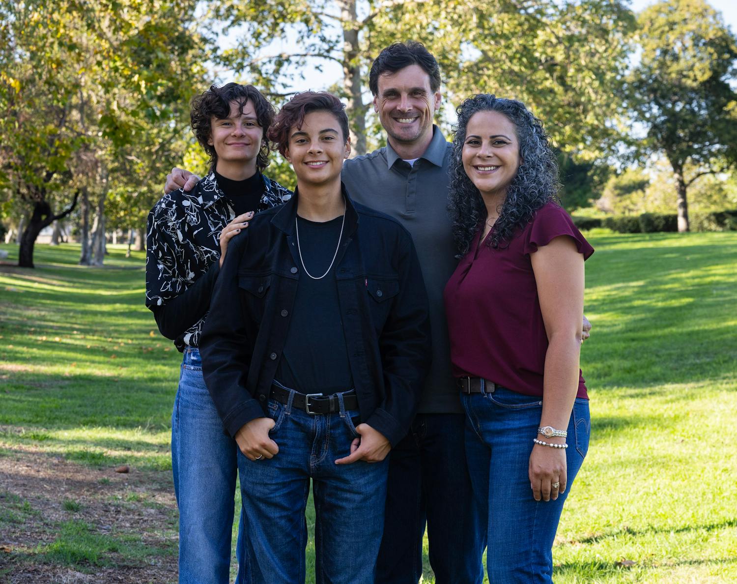 Chris Kluwe standing alongside his wife and two children
